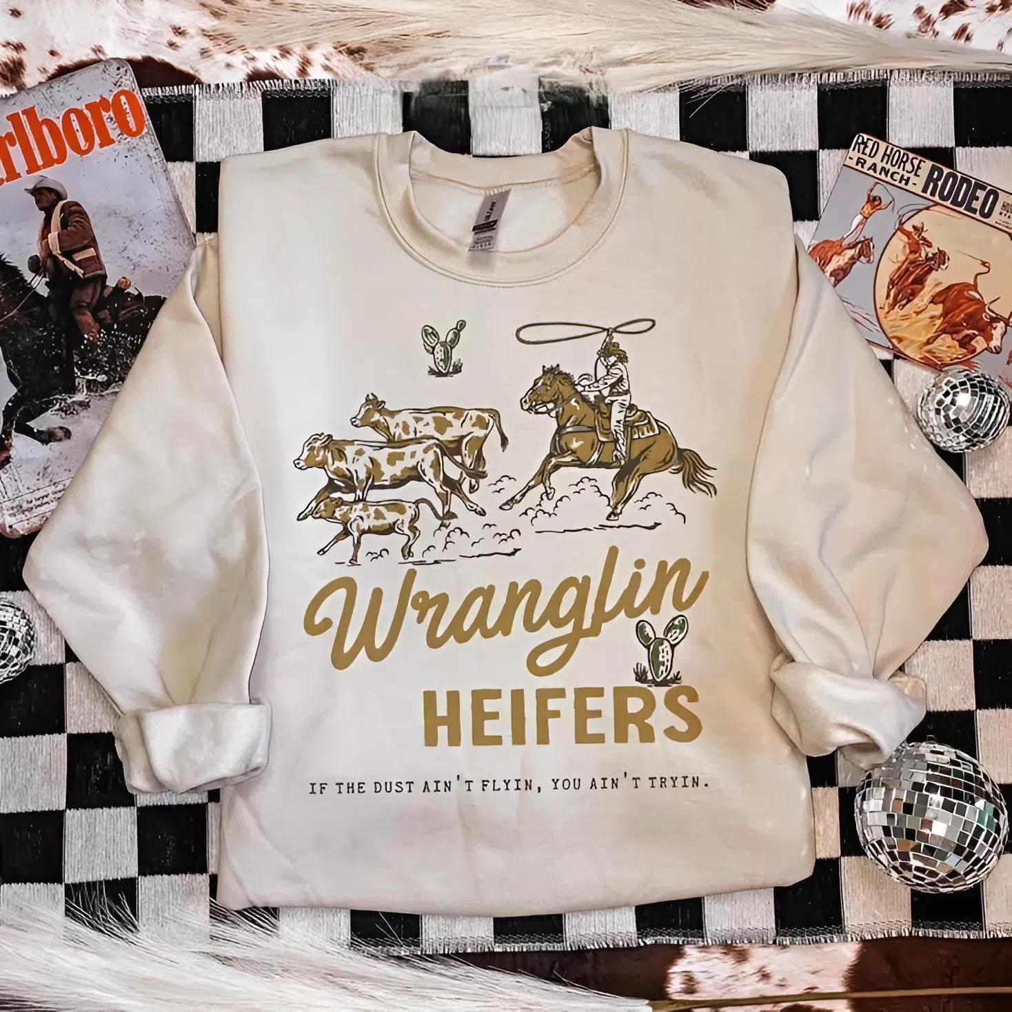 Wranglin’ Heifers Sweatshirt, western outfits, western clothing, crewneck western outfits, women’s clothes, country western tops, sweatshirts for women, western graphic tee women, vintage graphic tee, cowgirl sweatshirt, women country clothing