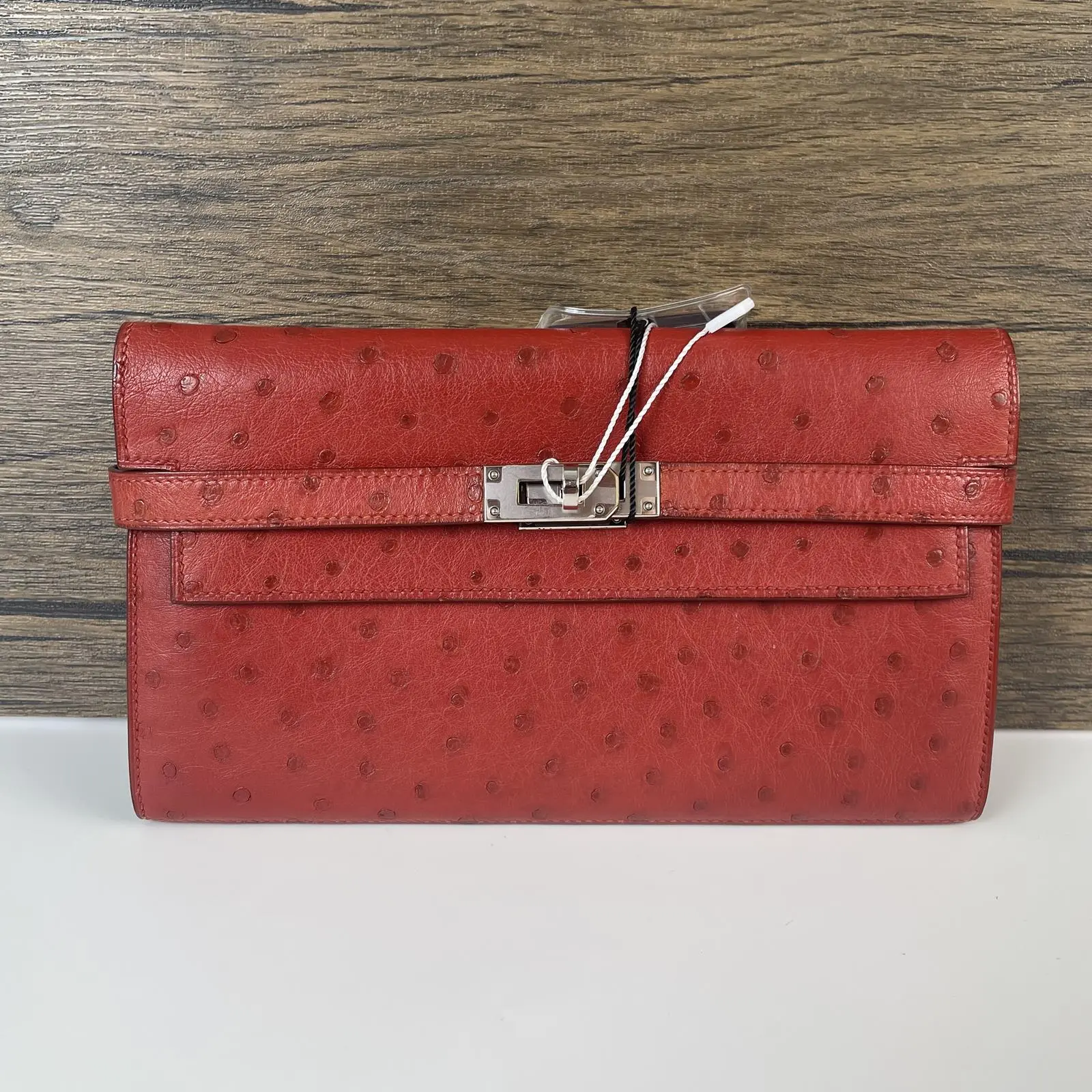 Pre-owned HERMÈS leather Clutches & Wristlets Pre‑Owned Red Ostrich Kelly Clutch with bag charm