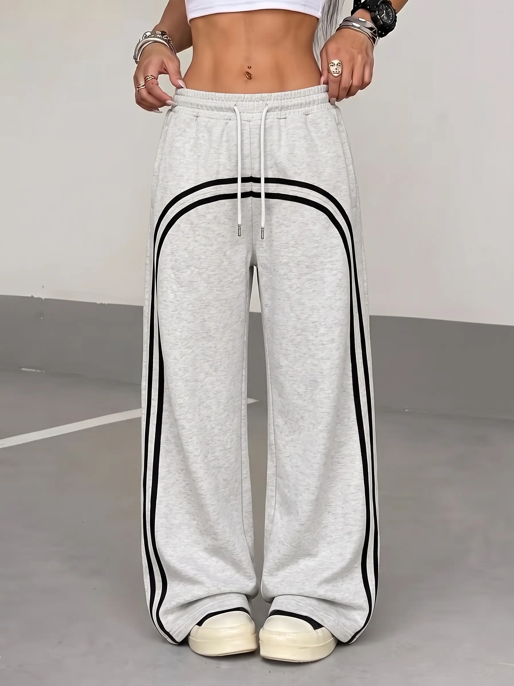Women’s curved double-stripe wide-leg sweatpants with elastic drawstring waist and side pockets, cotton blend fabric—soft and breathable casual streetwear long pants suitable for women’s everyday wear, street style, and home lounging.