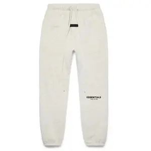 Fear of God Essentials Essential Light Oatmeal Pants with Drawstring Waist and Brand Tag for Comfortable Everyday Wear