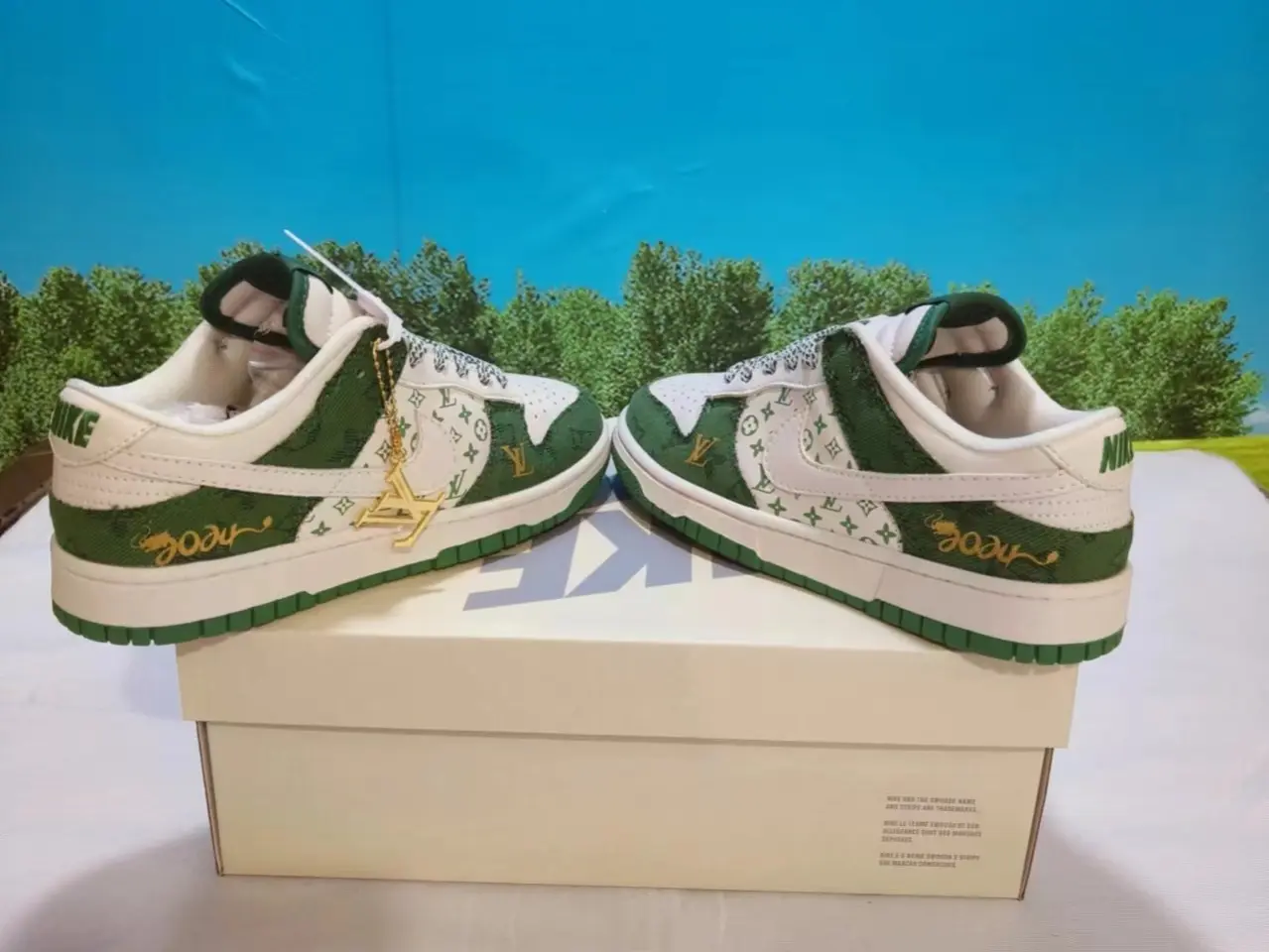 Daily wear street sneakers constructed with patterned denim and smooth leather, milky white base matched with rich forest green overlays and golden embroidery accents, lightweight rubber outsole ideal for every casual daily occasion