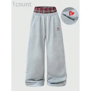 Comfortable gray wide-leg sports pants with a checkered waistband and LA heart-shaped embroidery 💕 | Fashionable streetwear vibe | Comfortable loose fit + side stripes | Perfect for casual wear GARMENTARY
