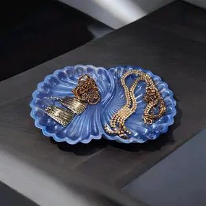 Blue Jewelry Holder with Decorative Elements and Metallic Accents