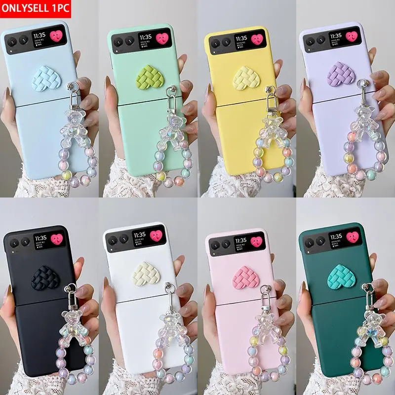 Candy-colored heart-shaped phone case with a small bear pendant bracelet. The hard PC back plate protects the phone. Compatible with Motorola Razr 2023/Razr 40