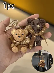 Brown sitting teddy bear keychain with tag and bow tie - made of resin with a textured look, sitting design, lively eyes and ears, gold-black nose - a fashionable accessory for women, can be used as a car key or bag charm Cute Keychain Teddy Keys