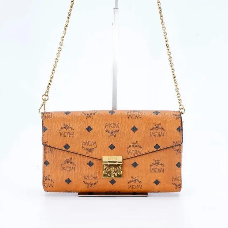 Pre-owned MCM medium envelope bag with chain strap, brandy color