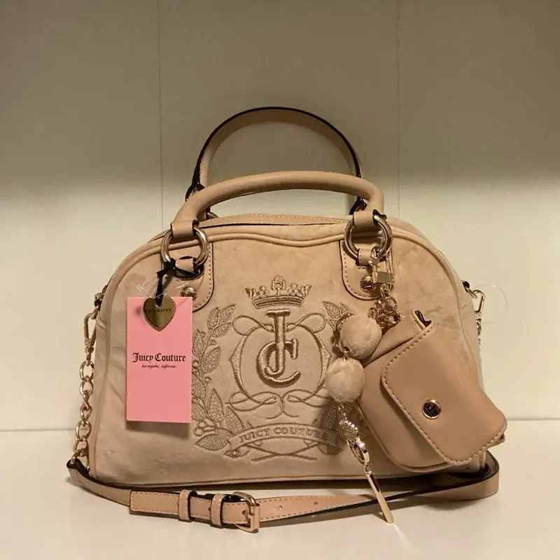 Juicy Couture - sparkle royal satchel in the color buff beige