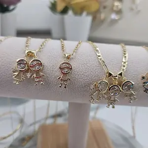 (66)  boy or girl pendant with figaro chain 14kgoldplated