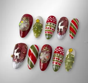 Festive Christmas nails with candy cane stripes, reindeer, ornaments, and 3D Christmas trees in red, green, and gold for a cozy holiday sparkle aesthetic