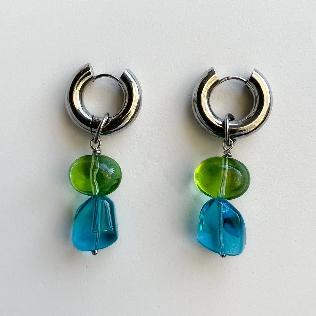 Stainless steel hoop earrings with interchangeable blue and green glass charms Female Female Female Elegant Female Female Female Female Elegant Casual Female Female Female Female