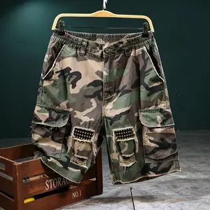 Men’s camouflage cargo shorts, 100% cotton, featuring a distressed edge design with studs and multiple pockets; loose yet fitted cut for comfort. Ideal for summer outings, outdoor sports, and street style—summer vibe apparel.