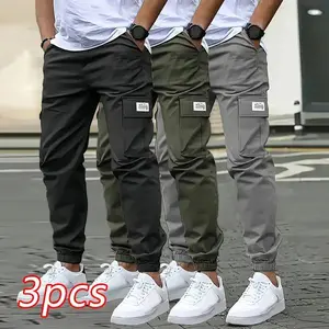 Men’s casual solid-color sports pants — multiple flap pockets, drawstring waist, polyester fiber; suitable for outdoor work, running, streetwear, and jogging; also available as lace-up underwear.