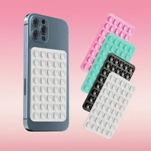 This suction cup phone holder has 40 suction cups on both sides, compatible with iPhones and Android phones, making it ideal for attaching to mirrors or in the shower. It adheres firmly to smooth, flat surfaces with strong suction and is universally compa