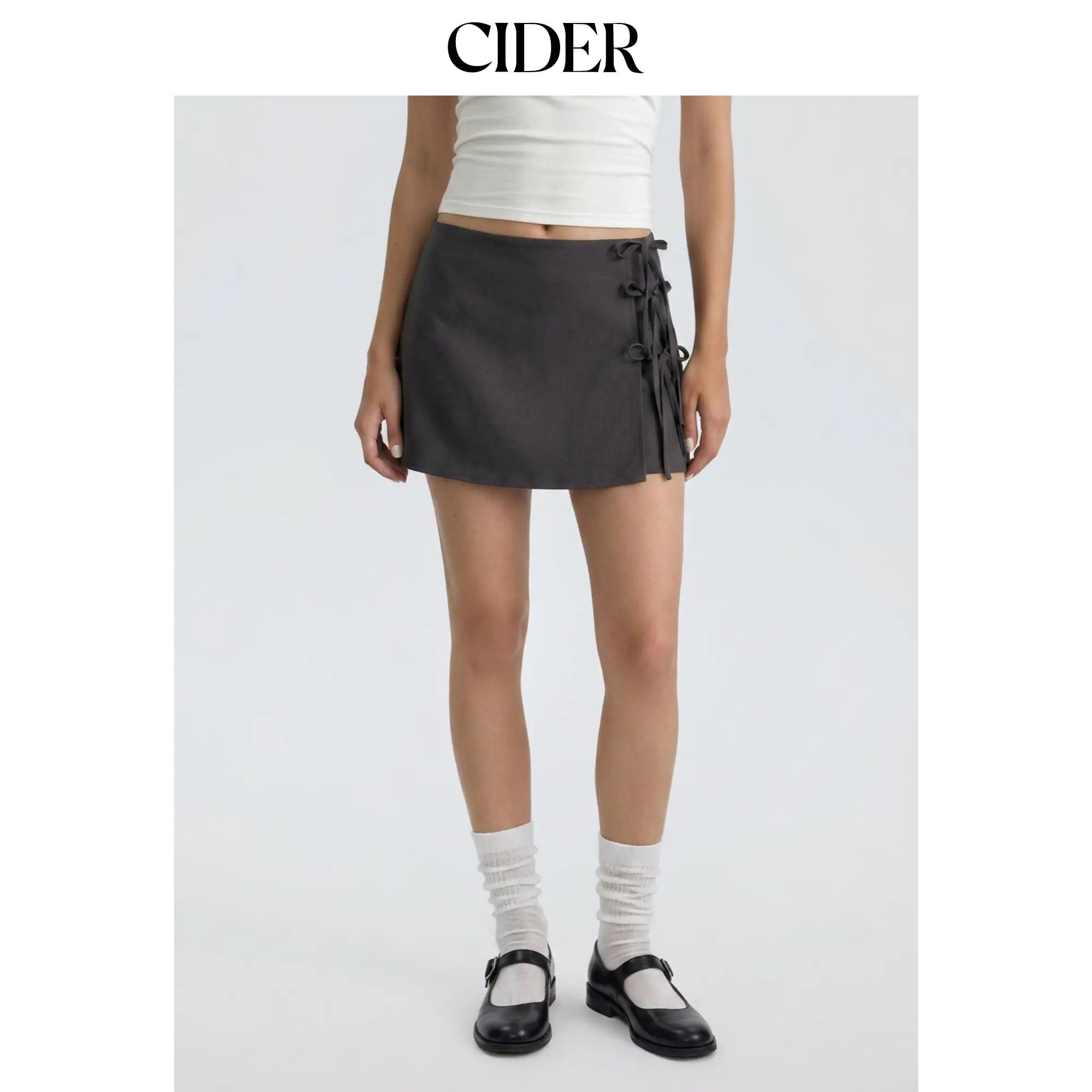 Cider Women's Solid Low Rise A-line Mini Skirt in a Polyester Elastane Blend with Side Tie Bowknot Detail, Above Knee, Female