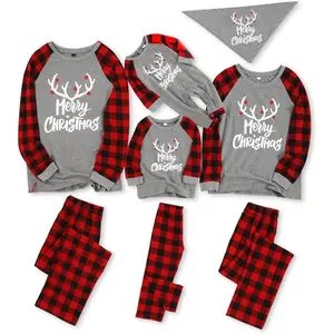 Matching family Christmas pajamas set featuring a long-sleeve letter-print T-shirt and plaid-print bottoms for lounging
