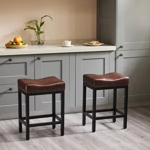 Brown Set of 2 Counter Bar Stools, 23 Inch Height, Perfect for Kitchen Islands. Features Upholstered PU Leather Seats with Thick Saddle Cushioning, Sturdy Metal Base, and Comfortable Footrests