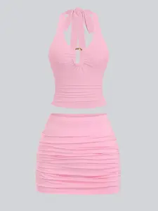 Halterneck spaghetti strap Crop cami with ruched details, metal clasp tie, and open back. Fitted ruched mini skirt. Sexy and comfortable - perfect for beach days and casual outings. Outfit