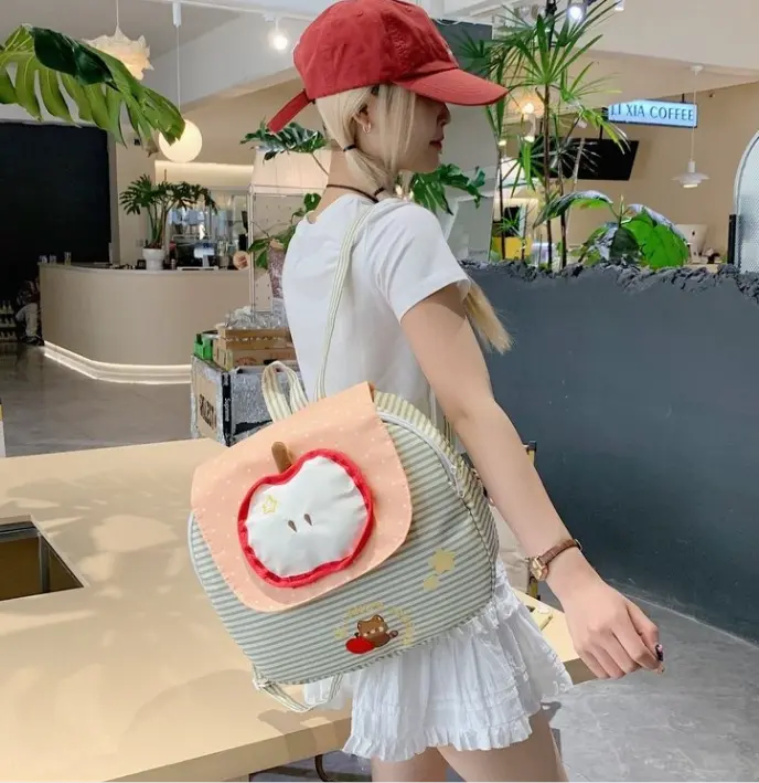 Korean-style mint green striped backpack—cute, fresh, "forest-style" aesthetic with an apple motif; perfect for a campus look.