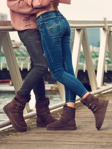 A pair of AU&MU Australian sheepskin snow boots with classic and retro style for warmth and slip-resistant magic tape cuffs, fashionable for women's daily commuting, work, and shopping.