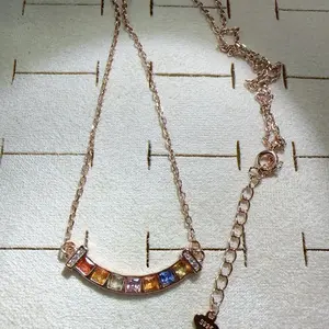 <PingEast jewelry > 925 sterling silver pendant necklace with 18K rose gold plating, set with seven 3*3mm multicolored sapphires (yellow, cornflower blue, pink, orange, red) in a smile chain design. Comes with a certificate.