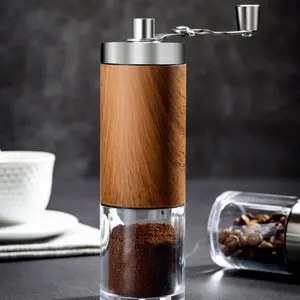Portable stainless steel manual coffee grinder with wood grain finish, kitchen tool.
