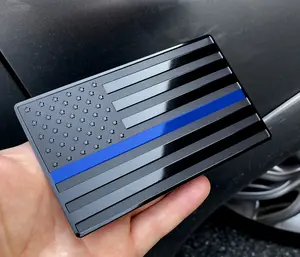 American embossed stainless steel metal flag, suitable for cars and trucks, expressing support for police and law enforcement officers, black background with thin blue lines, measuring 5 inches x 3 inches.