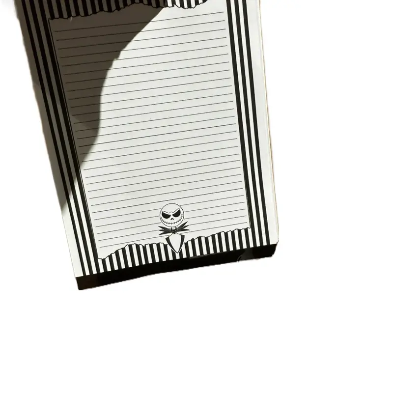 Black and White Notepad with Striped Design and Jack Skellington Illustration
