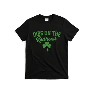 Funny Irish Drinking T Shirt Featuring Dibs on the Redhead Text in Green Lettering Soft Breathable Fabric Perfect for Pub Crawls and Parties Unisex Casual Graphic Tee