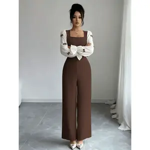 Women’s coffee-colored colorblock jumpsuit with a contrast spliced design, featuring a square neckline, puff sleeves, bow decoration, and flared cuffs; suitable for spring and autumn, ideal for daily commuting and home wear.