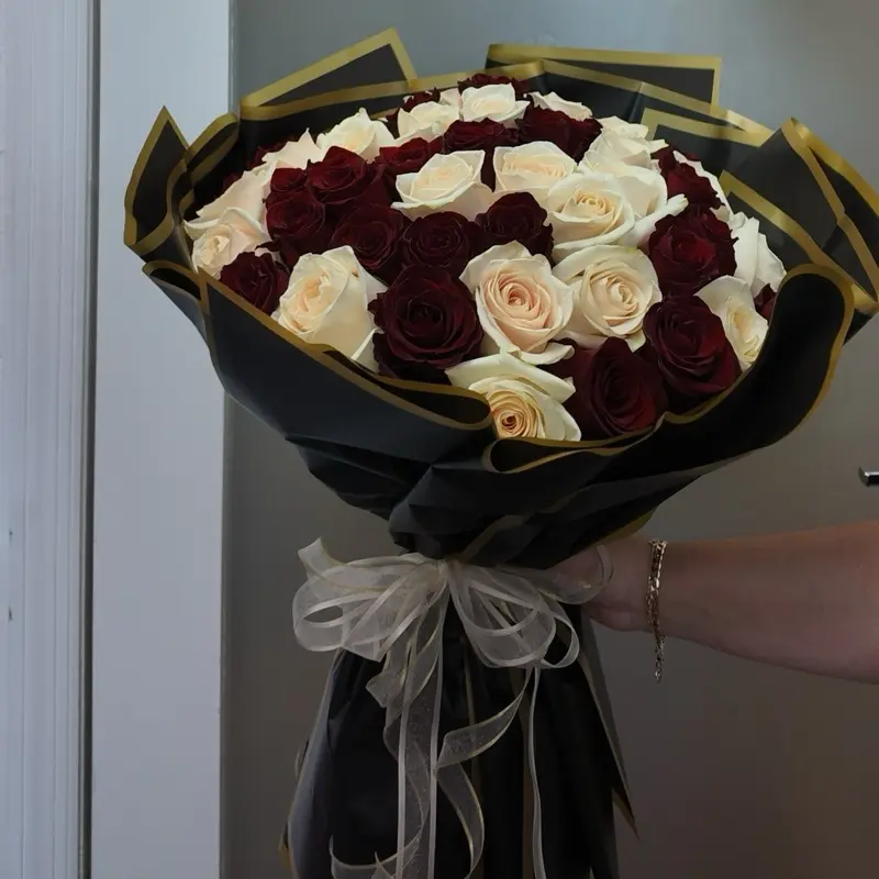 50 Red and White Roses Bouquet with Elegant Black and Gold Packaging and Sheer Bow for Special Occasions