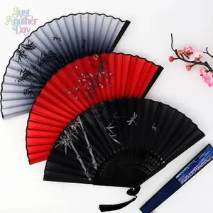 Stylish vintage bamboo folding fan with tassel - Portable handheld summer fan, perfect for celebrations, events, and gifts.  Features a solid color design with floral details.  Event accessory | Decorative fan | Easy-to-carry fan