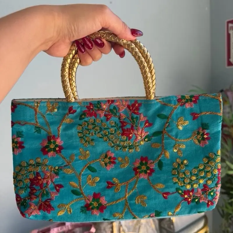 Turquoise Embroidered Handbag with Gold Accents and Floral Design for Special Occasions