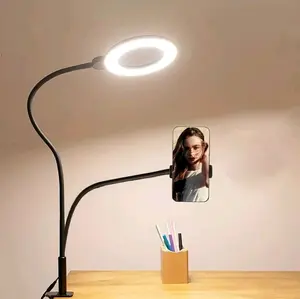 A Phone Stand with a Supplementary Light, Featuring a Clip-On Design, a Ring-Shaped Selfie Light, 2-In-1 Functionality, Suitable for Desktop Reading And Video Lighting, Adjustable And Rotatable for Selfies, Video Recording, And Makeup.