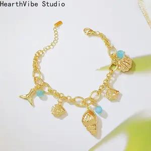 Ocean-Style Bracelet featuring Shells, Conch, and Mermaid Tail — 18K Gold-Plated with Blue Cat's Eye Stone