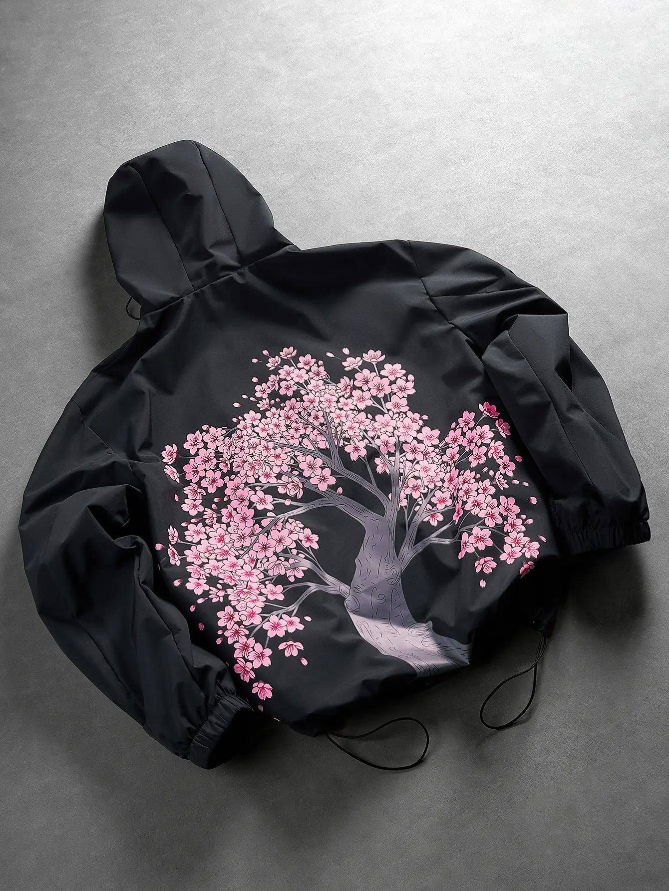 Men's loose-fit hooded windbreaker jacket featuring a cherry blossom pattern on the back, elastic cuffs, and a drawstring hem; casual streetwear outerwear.