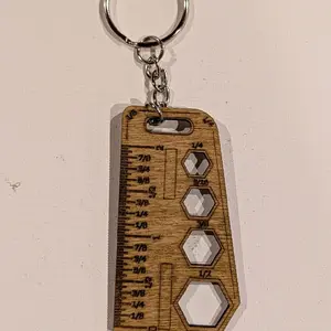 Ruler keychain with markings.