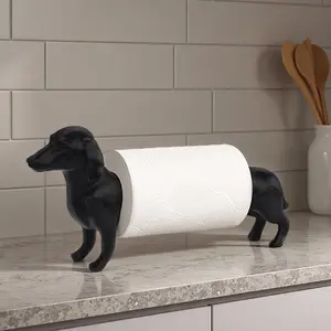 A humorous sausage dog-themed toilet paper holder - an independent black roll holder featuring a cute dog design, made of sturdy plastic and also suitable for kitchen paper towels