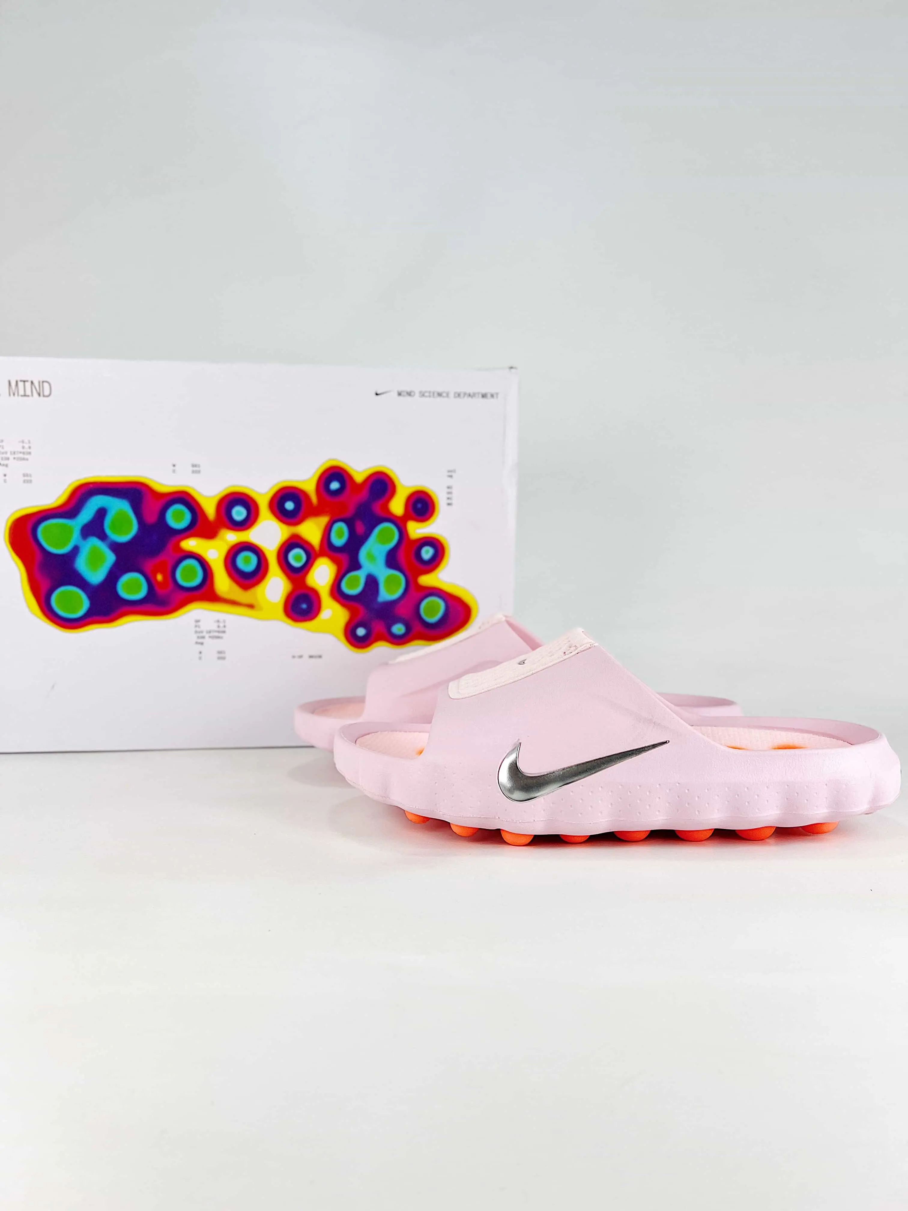 Solid pale pink smooth rubber recovery slide sandals featuring scuff-proof bumpy bright orange gum rubber outsoles, tear-resistant sweat-wicking soft breathable mesh strap construction, built-in footbed massage bump cutouts