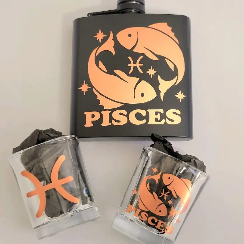 Pisces Zodiac  Flask Set – Rose Gold Edition Product Highlights  - Includes: 1 Pisces flask (6 oz), 2 square shot glasses (2 oz each), 1 mini funnel   - Rose gold metallic detailing with Pisces glyph, Pisces symbol,   - Matte black stainless Steel