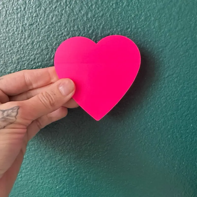 Pink transparent heart shaped sticky notes for book annotation