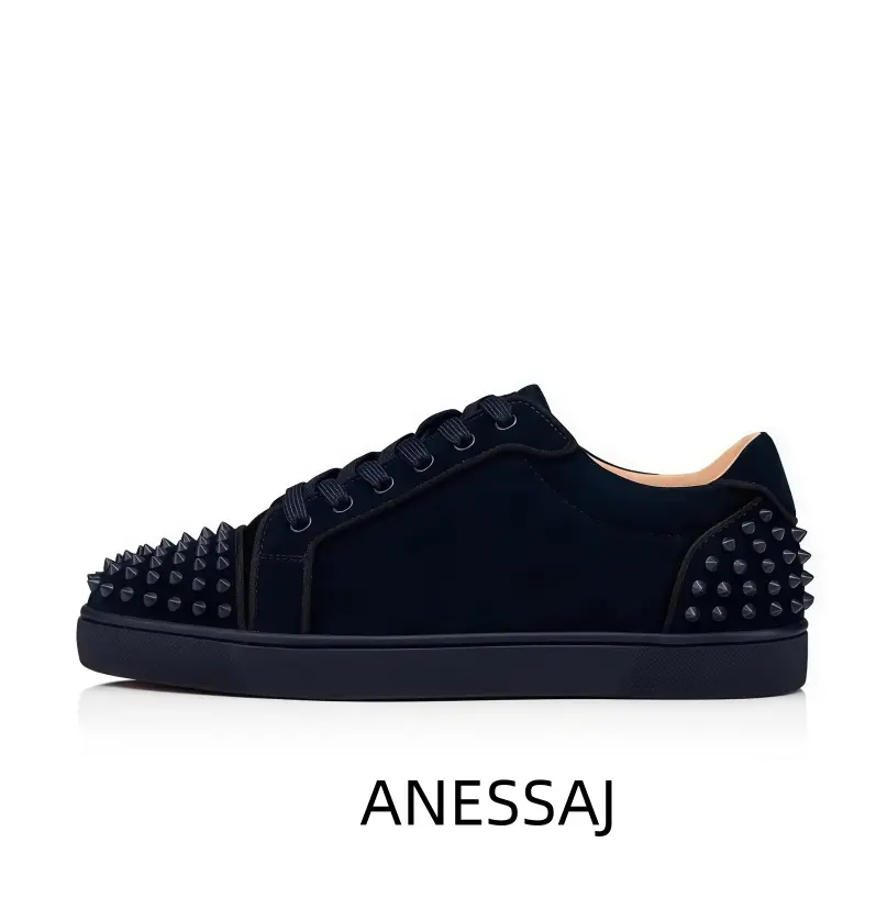 Black low top shoe with spike stud detail, black suede graphic, black midsole, black rubber outsole, lace up closure, sporty athletic footwear