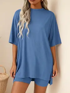 Loose modal fabric casual skin-friendly high-stretch women’s rib knit two-piece set: crew neck drop-shoulder mid-length top with slit and fitted high-waisted shorts. Solid color relaxed vibe loungewear sleepwear. Versatile for everyday wear, going out, wo