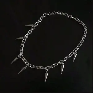 Spiked chain necklace  - A silver chain necklace with multiple spike pendants for a bold, edgy look.