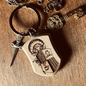 Granny’s Protection Charm Keychain. Wood engraved with a portrait of Granny Goblin holding her shield for her goblings.