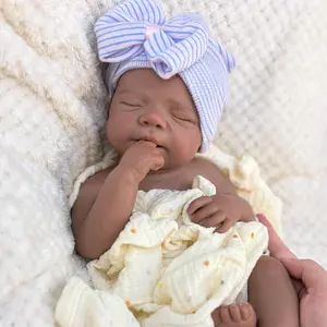 Reborn doll, soft silicone — 18 inches tall, lifelike with closed eyes for sleeping, brown skin, a soft body, and realistic detailed features. Includes a comfort item, a bottle, and a birth certificate. Perfect for birthday gifts, collectors, and children
