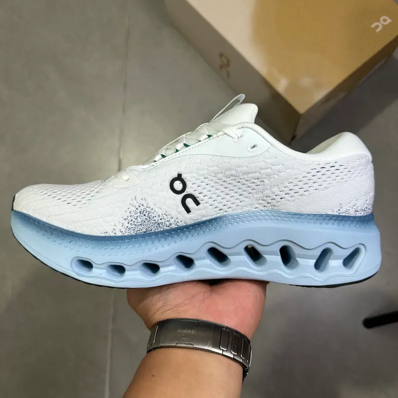 White sky-blue two-tone hollow cushioned low-top running trainers featuring scuff-proof pale rubber outsoles, tear-resistant sweat-wicking stretch knit mesh construction, mesh embedded airflow cutouts, wavy hollow lightweight foam midsole layout