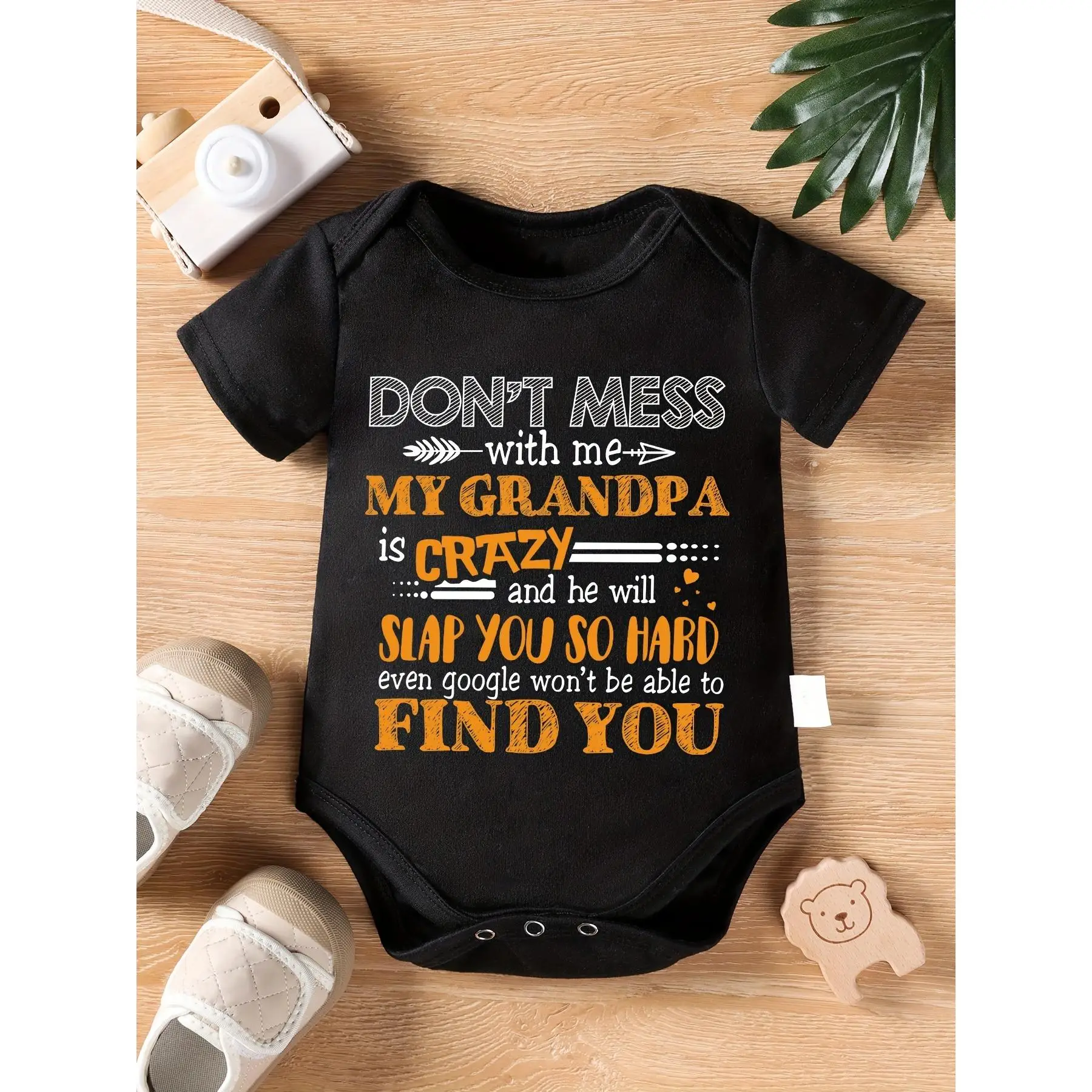 Don't Mess with Me, My Grandpa Is Crazy..." - Humorous Black Cotton Baby Bodysuit with Orange & White Text, Short-Sleeved, Round Neck, Machine Washabl