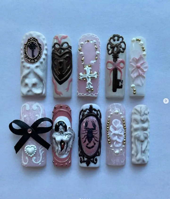 Victorian goth nails with keys, corset bows, cameos & rosaries in soft pinks and whites—elegant, eerie, and baroque to the bone