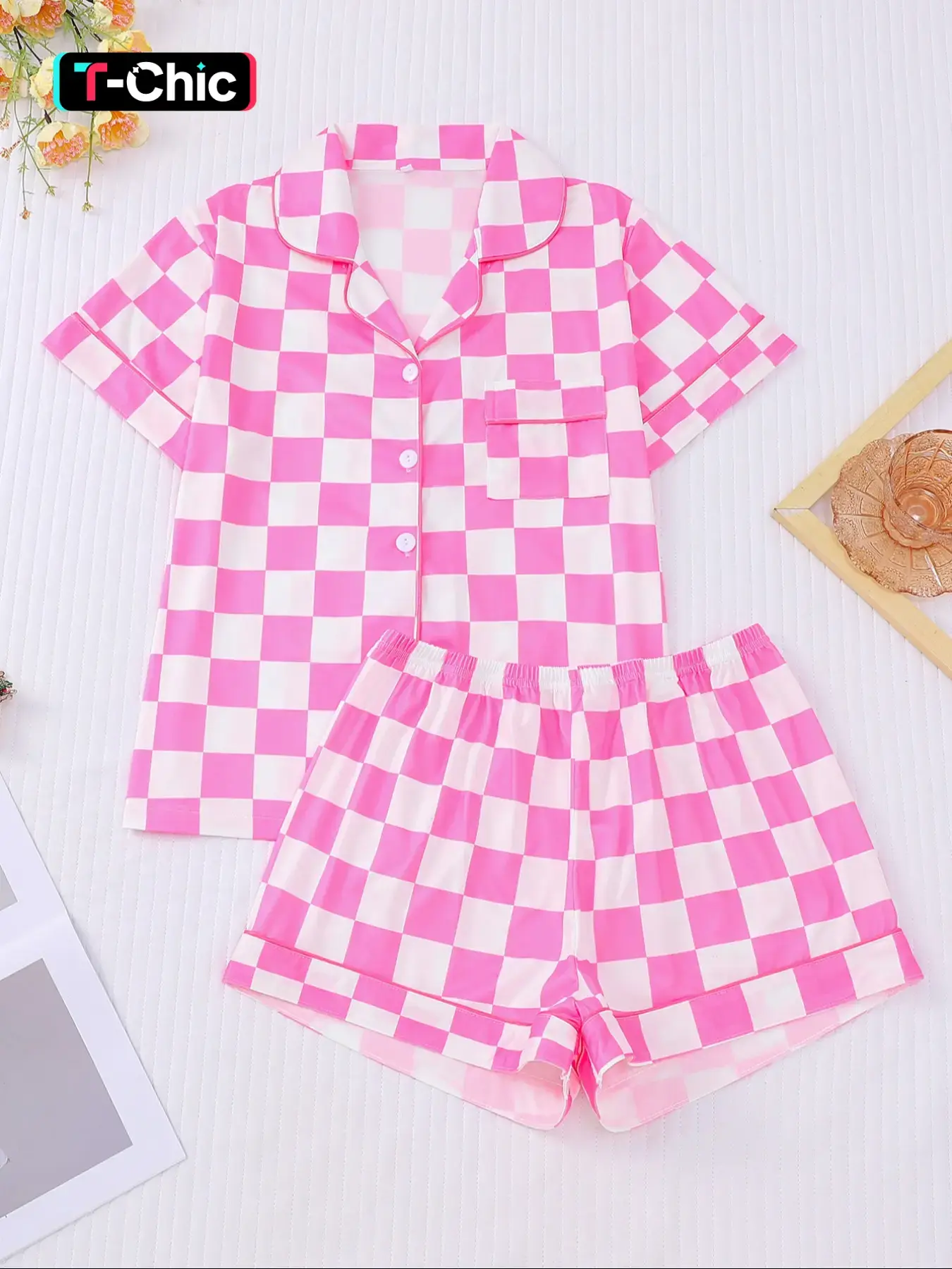 This checkered pajama set in vibrant pink and white is a summer essential, Loungewear. The lightweight fabric keeps you cool all night, while the classic button-down style adds a cute touch. The shorts are stretchy and comfortable, perfect for lounging