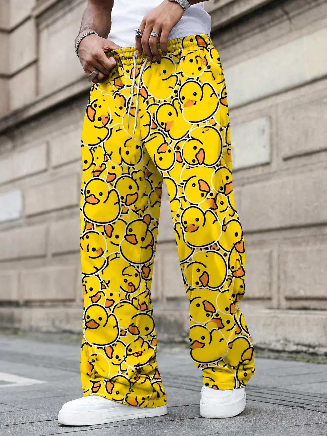 One men’s wide leg casual pants featuring an all over Little Yellow Duck print; urban relaxed style with a cartoon Little Yellow Duck design paired with an adjustable drawstring. Drapey fabric that shapes the legs, suitable for men’s everyday outings and